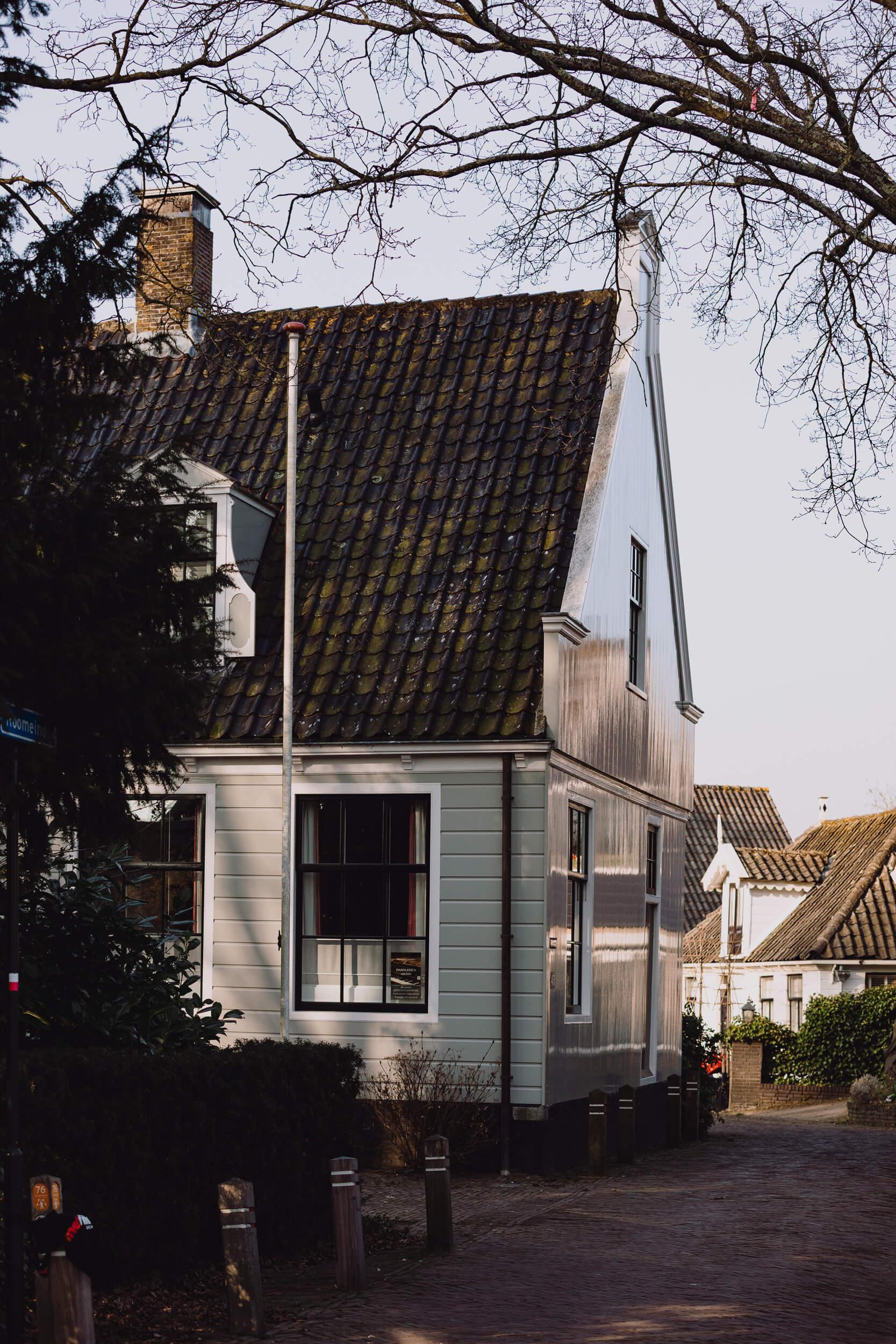 Refelction of the upcoming sun in a wooden Ditch heritage house in Broek in Waterland, 15 minutes from Amsterdam